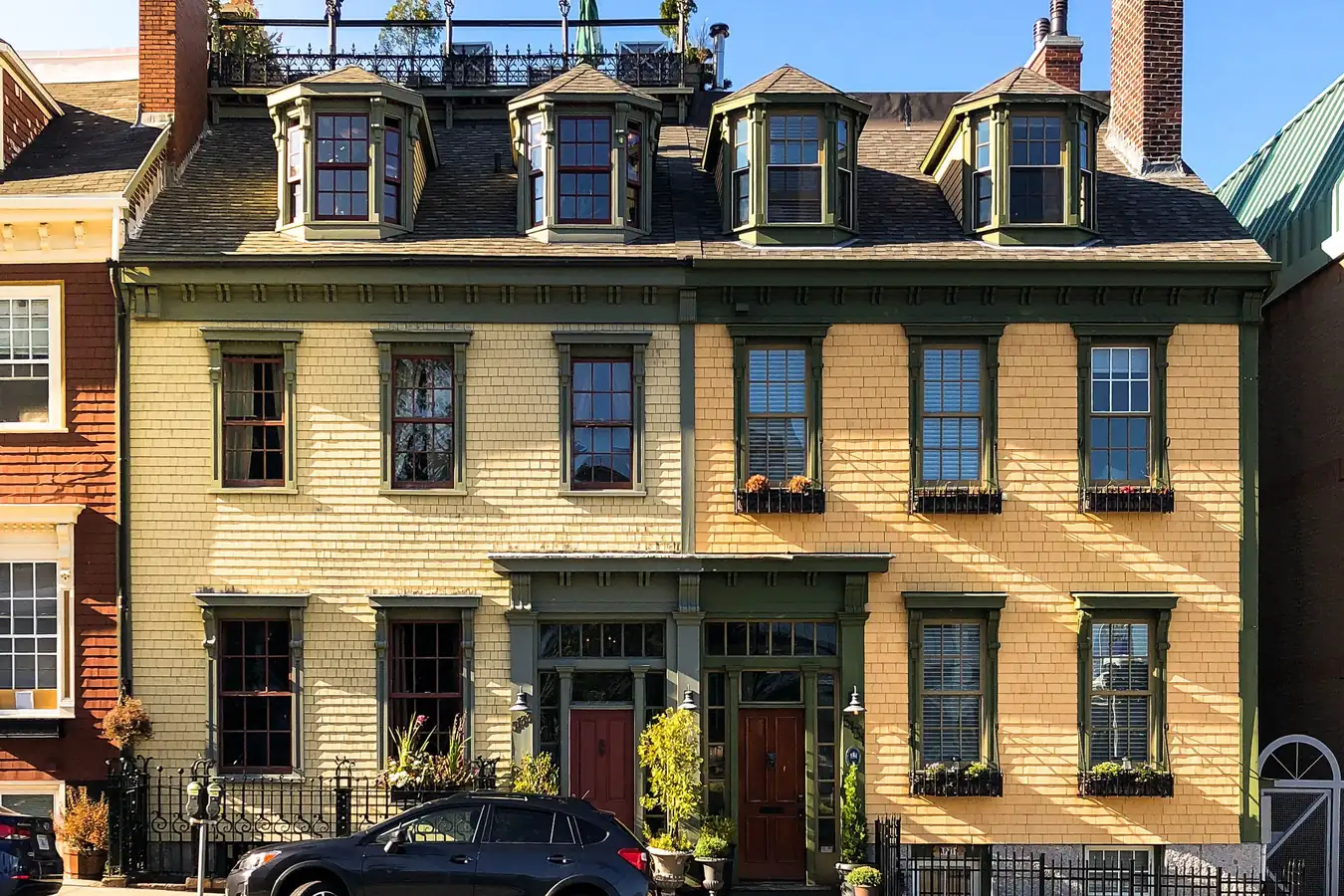 Pair of three-story attached houses with dormers and separate front doors